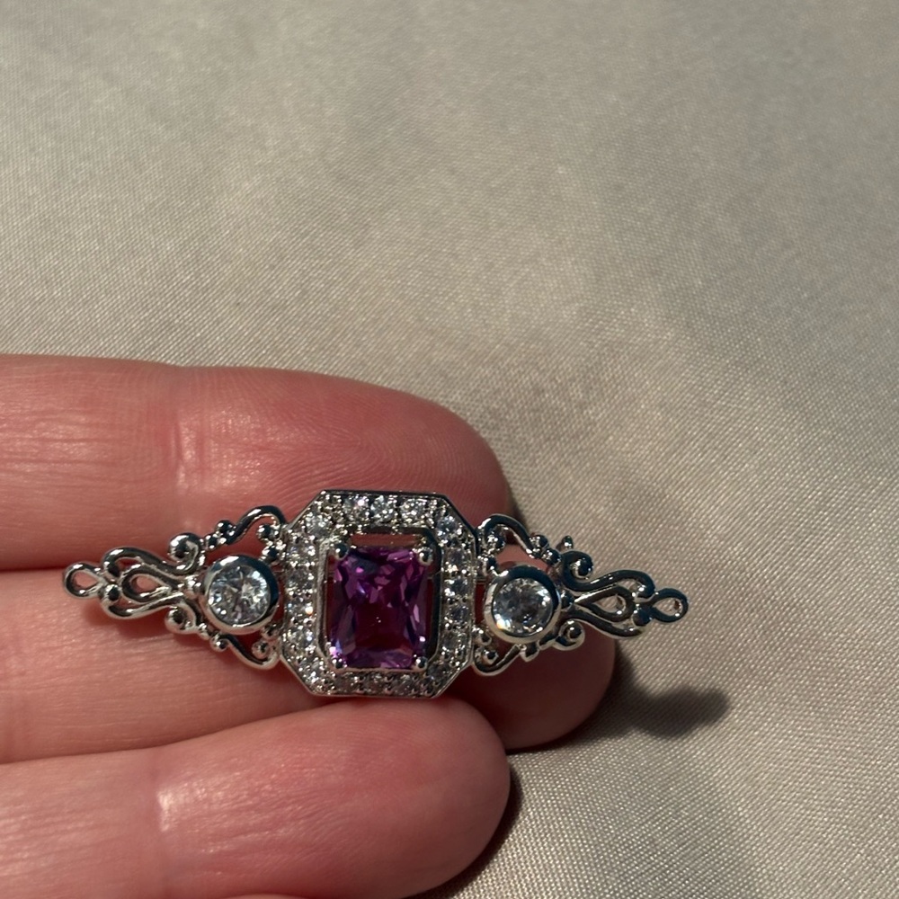 Ornate Silver and Purple Brooch with Intricate Design
